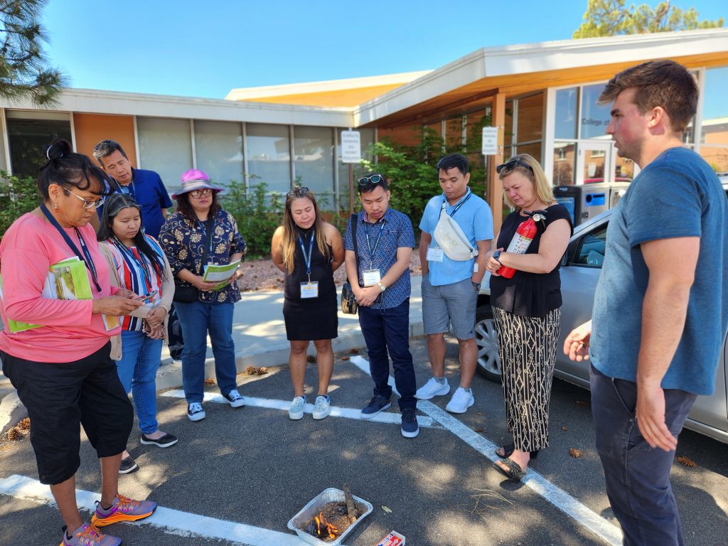 A group of teachers learns about a lesson from the fire ecology learning lab.