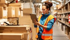 Stock photo of a woman checking inventory in a warehouse