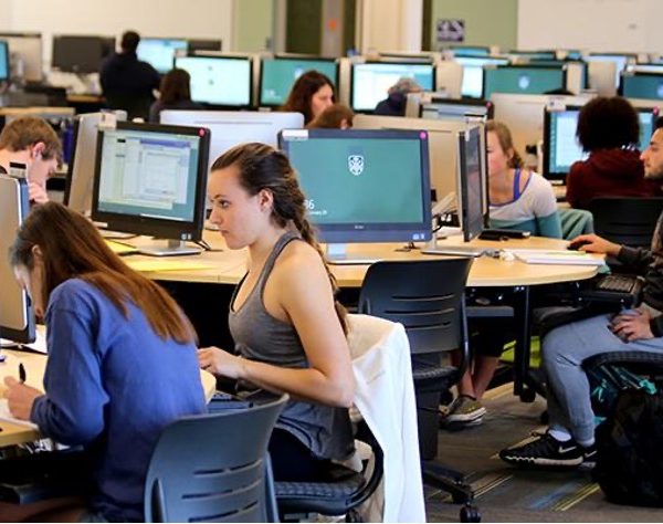 College students sit at computers in computer lab at Cline Library at NAU